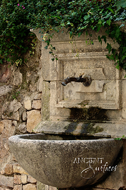 Ancient Reclaimed Stone Wall Fountain with an Angel Cherub Baby Face carved into the back of the fountain. Provenance, the south of France