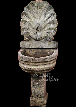 Ancient Reclaimed Stone Wall Fountain with an Angel Cherub Baby Face carved into the back of the fountain. Provenance, the south of France available in stock