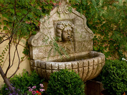 Hand carved stone wall fountain
