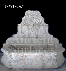 Hand carved stone wall fountain